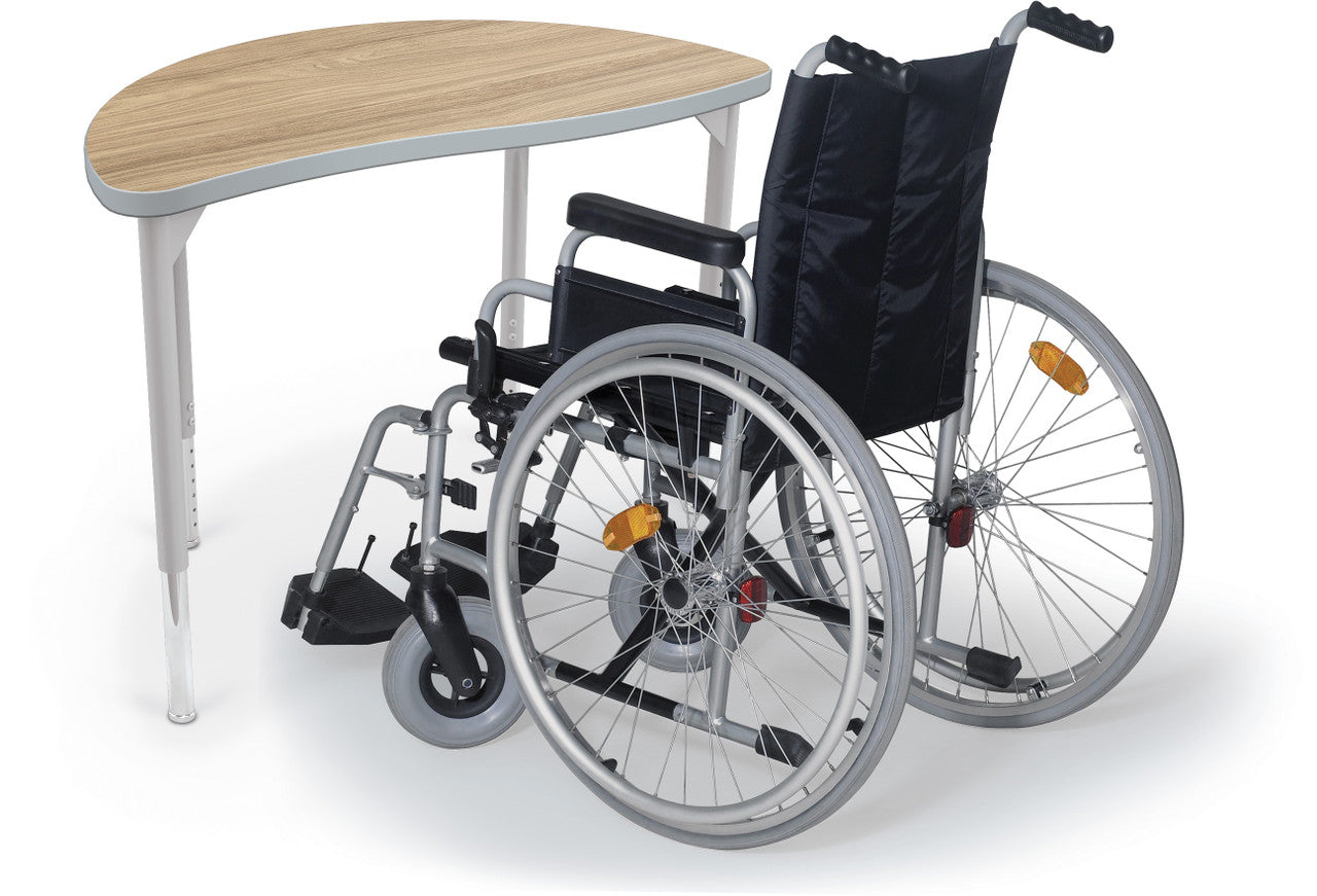 Hierarchy Creator Desks — Half Round (ADA). Shape verified from retailer product page; finish, leg color and height setting representative. Wheelchair and props shown are not included.